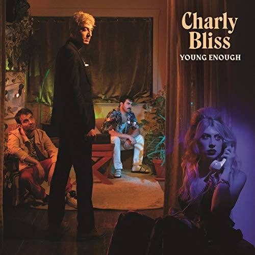 "Album cover with four people in a dimly lit room, 'Charly Bliss Young Enough' text."