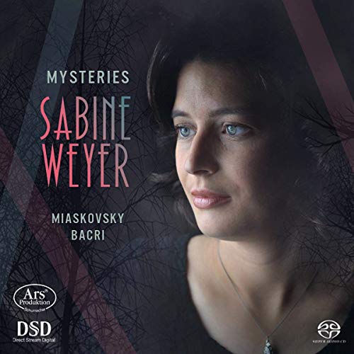 CD cover featuring a woman with dark hair and blue eyes, abstract background design.