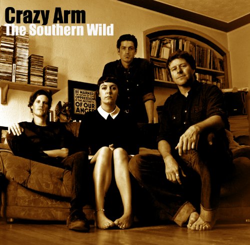 "CD cover with four band members posing on a couch, sepia-toned image."