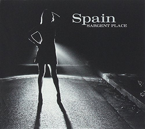 "Album cover featuring a silhouette of a woman standing on a road at night."