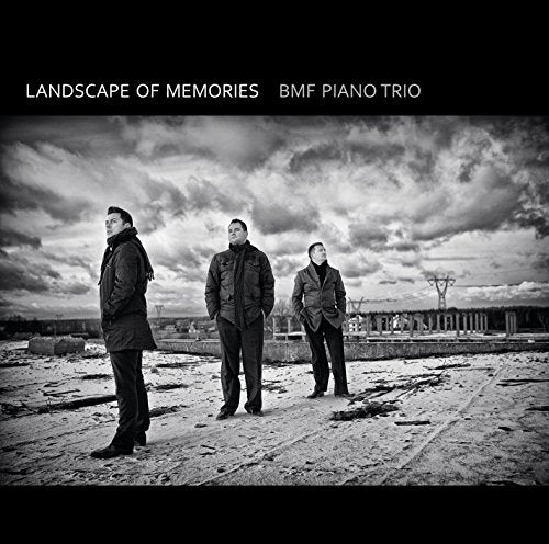 Black and white album cover with three men standing on a rocky surface.