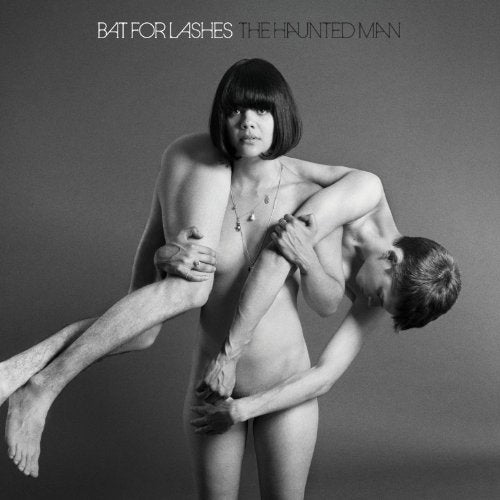 Black and white album cover with nude man and woman embracing.