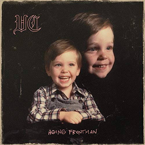 Vinyl record cover with a man and child smiling together against a dark background.