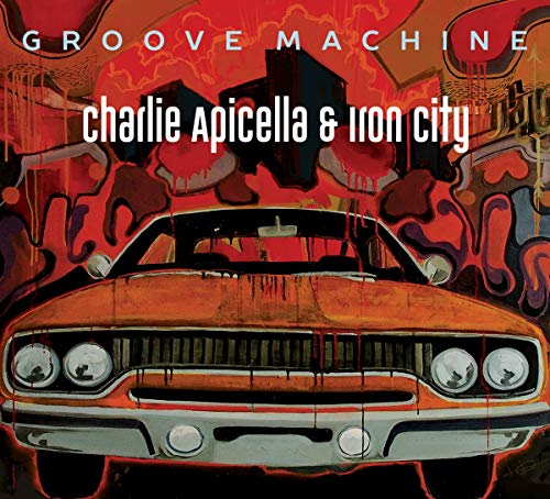 "Album cover featuring orange car with graffiti background and white text."
