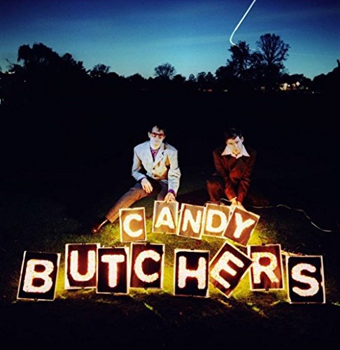 "Album cover with two men sitting behind 'Candy Butchers' in illuminated letter tiles."
