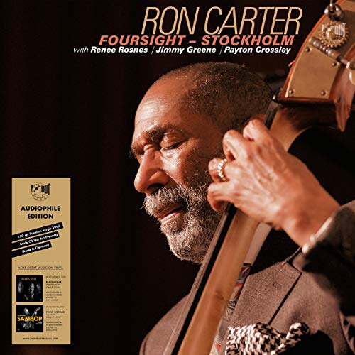 "Album cover featuring a man playing a double bass, with text at the top."