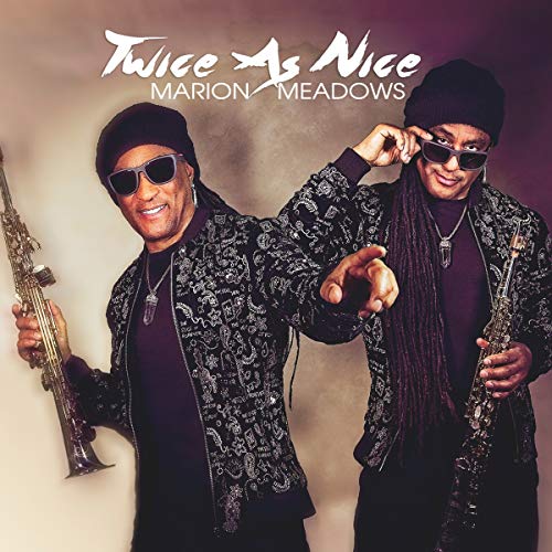 Album cover featuring a man holding a saxophone, wearing sunglasses and patterned jacket.