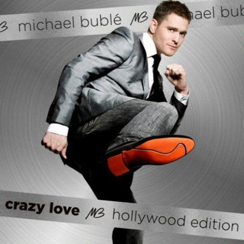 "Michael Bublé in a silver suit on a gray album cover."