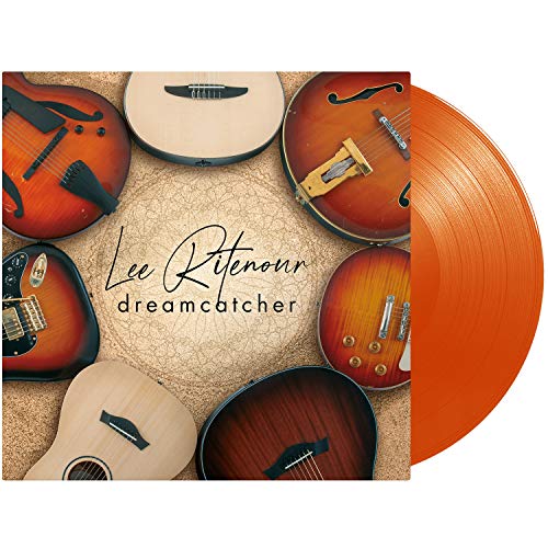 "Orange vinyl record with album cover featuring guitars on a beige background."
