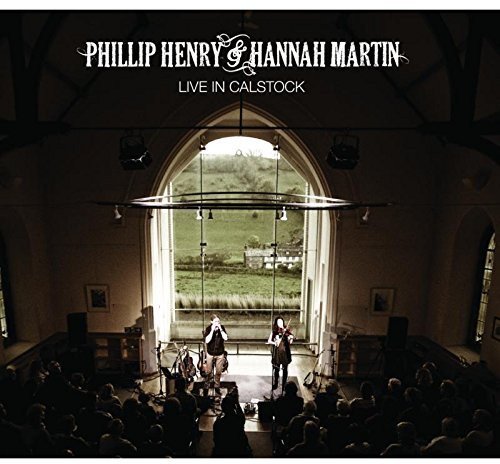 "CD cover featuring musicians performing on stage in a church with a crowd."