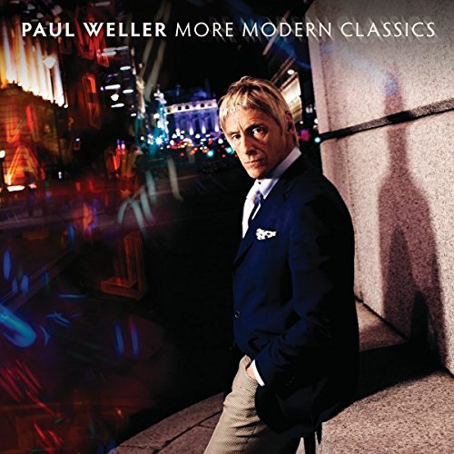 "Album cover featuring Paul Weller in a suit, leaning against a wall at night."