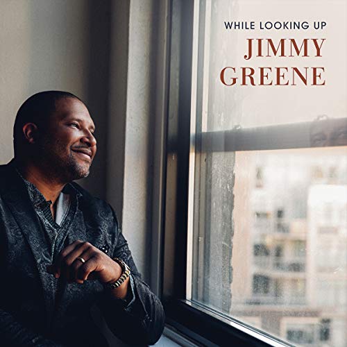 "Album cover with man looking out window, text 'While Looking Up Jimmy Greene'."