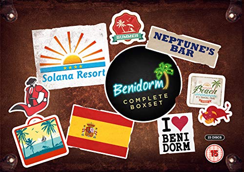 Brown suitcase with stickers, including "Benidorm Complete Boxset" and Spanish flag, on its surface.