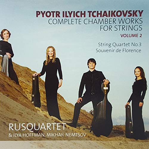 "CD cover featuring four musicians in black on a rocky hillside."