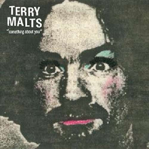 "Album cover with a close-up of a man's face, distorted and grainy."