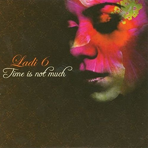 Album cover with a woman's face and pink floral overlay on dark background.
