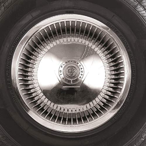 The alt text for the image is: "Black and white image of a hubcap with 'EJS' and 'decades to play' text."