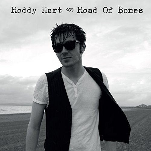 "CD album cover featuring a man in sunglasses standing in a field."