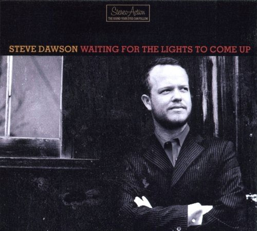 "Album cover with black-and-white photo of man in suit against a dark background."