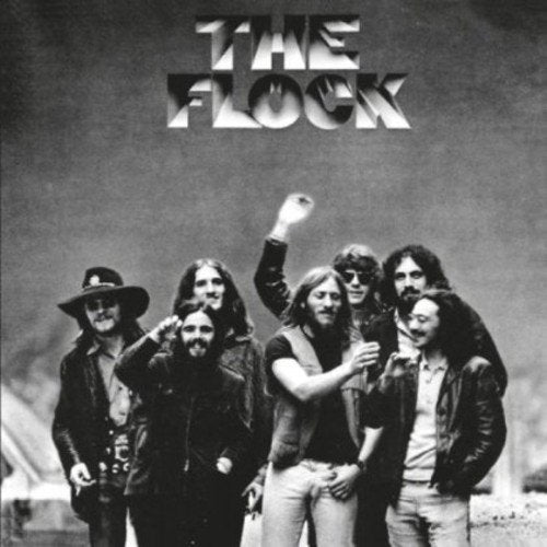 Black and white album cover featuring six men in casual attire standing together.