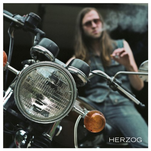 "Album cover featuring a man with long hair on a motorcycle, 'HERZOG' text."
