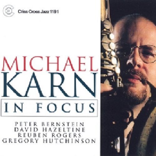 "Album cover featuring a man with glasses and a saxophone, with artist and title text."