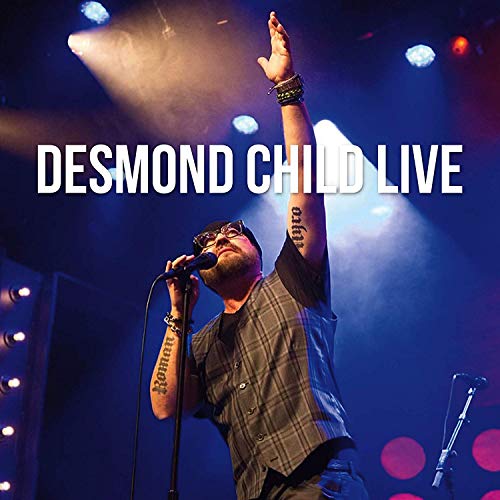 A man sings into a microphone with his arm raised, under stage spotlights.