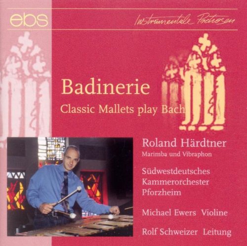 Red CD cover with a man playing a xylophone-like instrument.