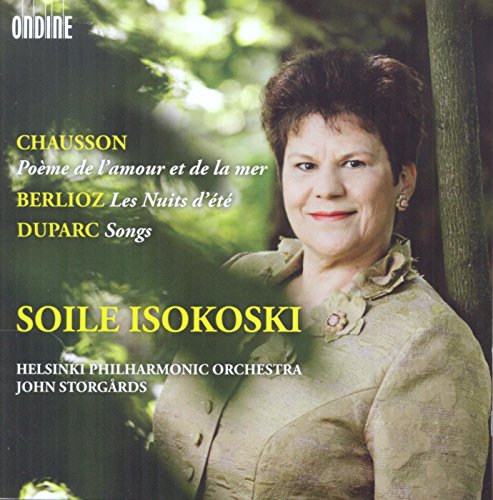 "CD cover featuring a smiling woman in a beige shirt, outdoors with trees."