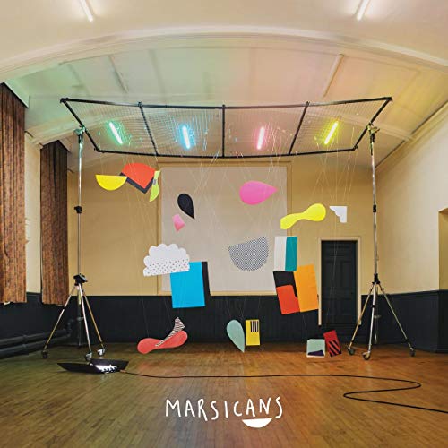 The image depicts a room with abstract shapes suspended from a grid. For accessibility purposes, a suitable alt text could be: "Abstract shapes suspended from a grid in a room."