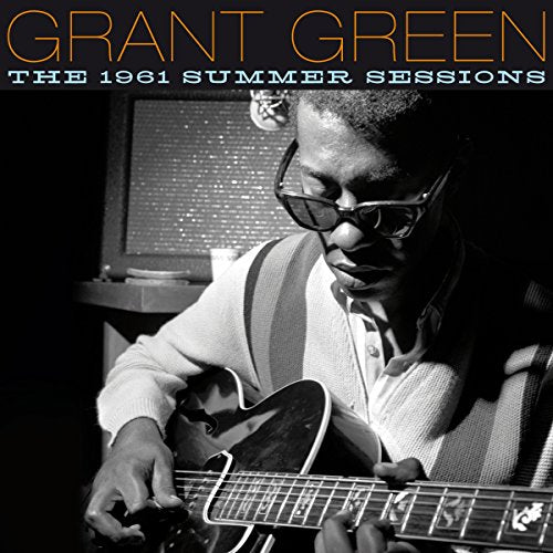Black and white album cover with Grant Green playing guitar, wearing sunglasses, in a studio.