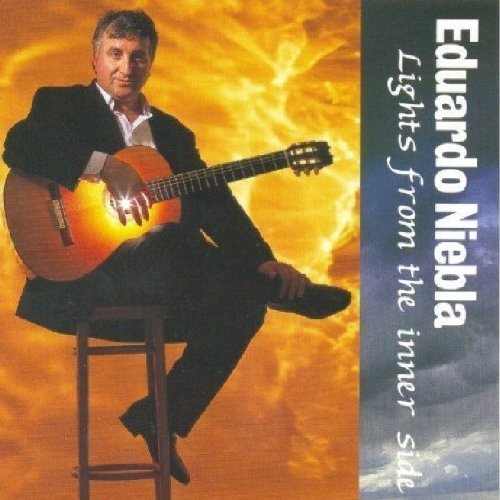"Album cover with man sitting on stool holding guitar, against vibrant orange background."