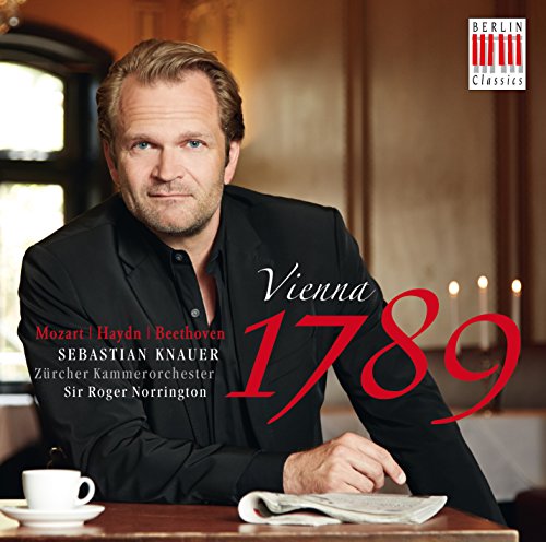 "CD cover featuring a man sitting at a table with a cup and sheet music."