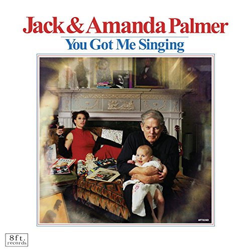"Album cover featuring a family of three sitting on a couch together."