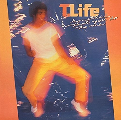 "CD cover with a man in white and yellow, surrounded by sparks on a blue background."