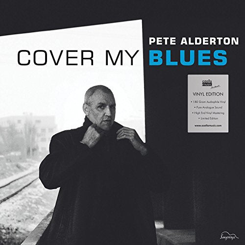 Vinyl album cover featuring a man adjusting his coat against a railway backdrop.