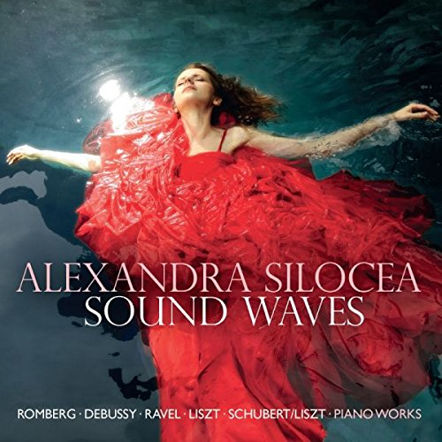 A woman in a red dress floats underwater with her arms outstretched.