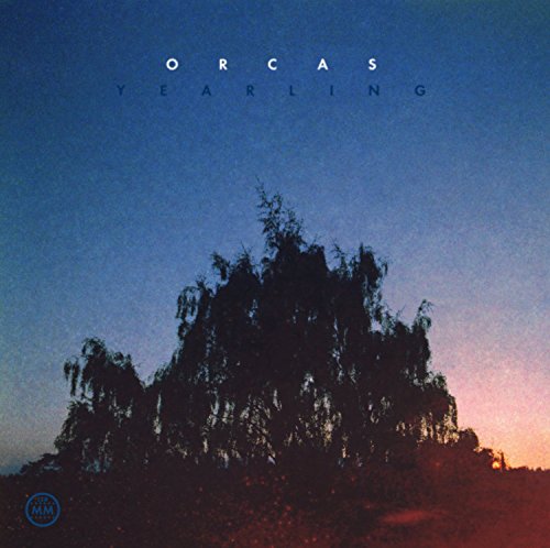 "Album cover with 'Orcas - Yearling' text, featuring dark trees against a blue-pink sunset sky."