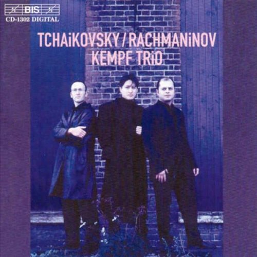 "CD cover featuring three men in dark attire standing before a brick wall."