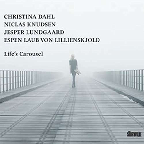"Album cover featuring a person walking on a foggy bridge, carrying a bag."