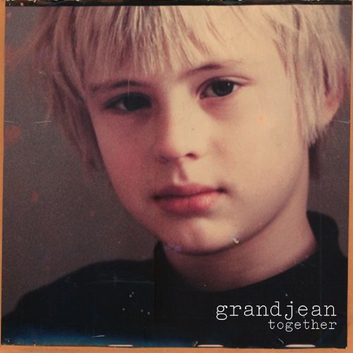 "CD cover featuring a young boy with blonde hair and dark eyes."