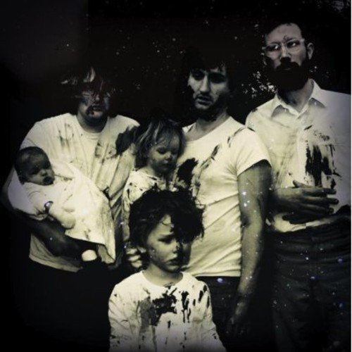 "Group of five men and a baby, with white shirts stained with dark splatters."