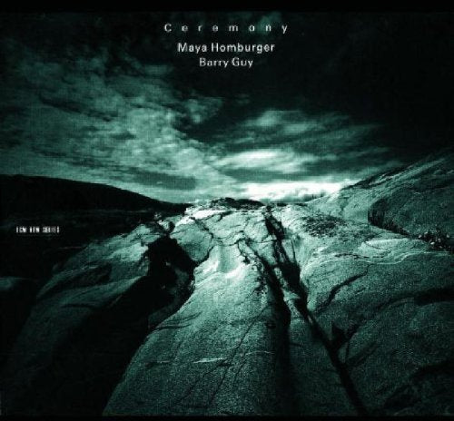 "CD cover art: dark, rocky landscape with cloudy sky and artist names."