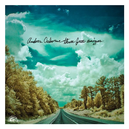 "Album cover with a road and trees under a cloudy blue-green sky."