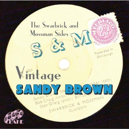 A yellow vinyl record with blue and black text, on a black background.