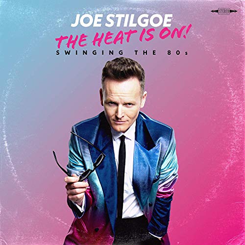Album cover with man in blue suit holding glasses, on pink and blue background.