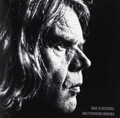 "Black and white album cover featuring a man's profile with long hair."