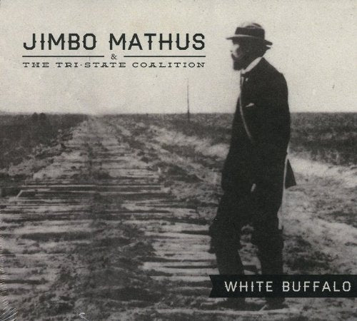 "Black and white album cover with man in suit walking on railroad ties."