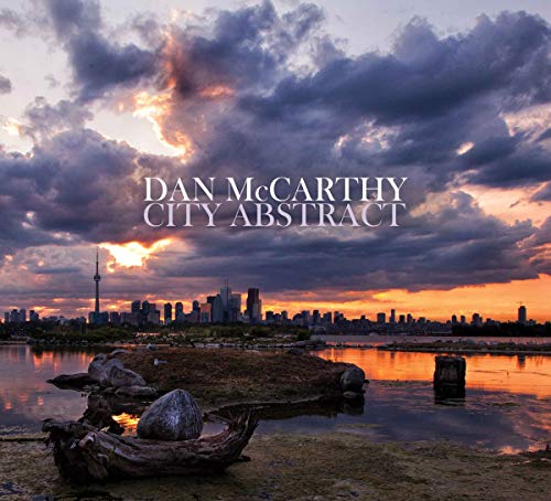 "Album cover with city skyline at sunset, cloudy sky, and water in the foreground."
