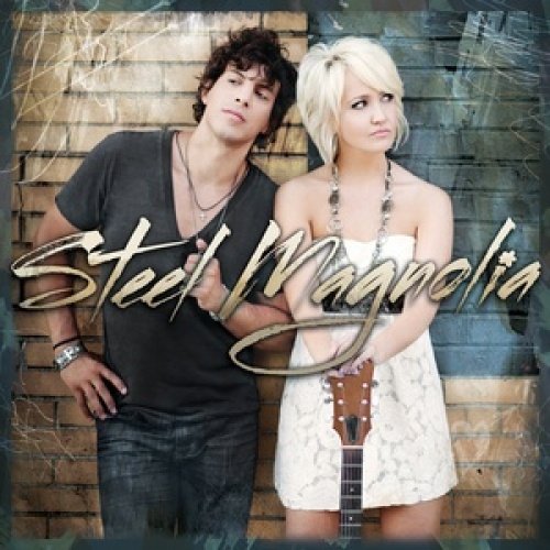 "Album cover featuring a man and woman standing against a brick wall."